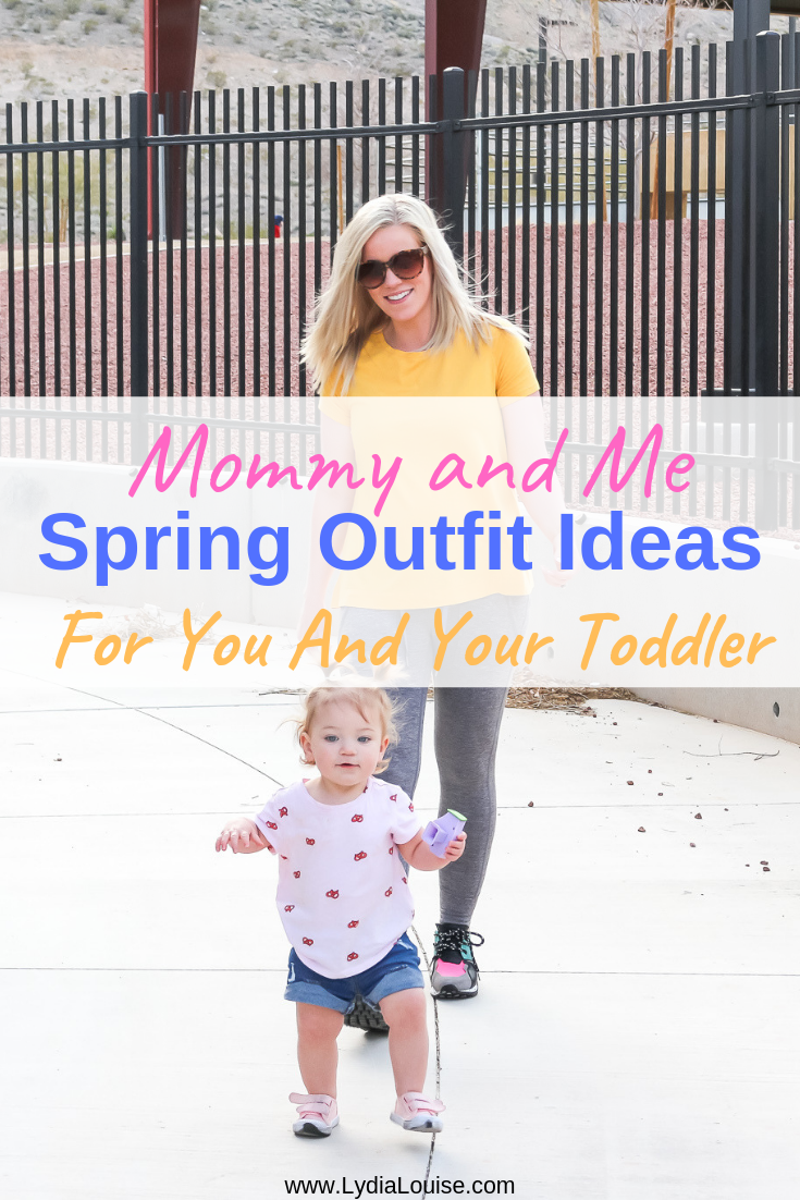 mom blogger and toddler daughter walking down sidewalk in spring outfits